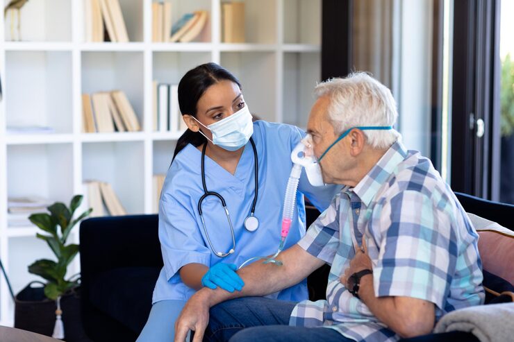http://biracial-female-doctor-examining-caucasian-senior-man-wearing-oxygen-mask-sitting-sofa-home_13339-332800