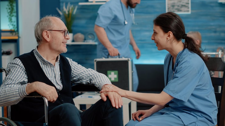 http://patient-with-physical-disease-getting-assistance-from-nurse-nursing-home-medical-assistant-talking-elder-man-sitting-wheelchair-about-healthcare-treatment-recovery-therapy_482257-28045