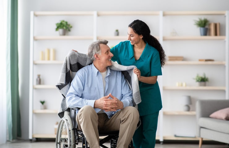 http://young-nurse-covering-disabled-elderly-man-wheelchair-with-warm-plaid-retirement-home_922936-30438
