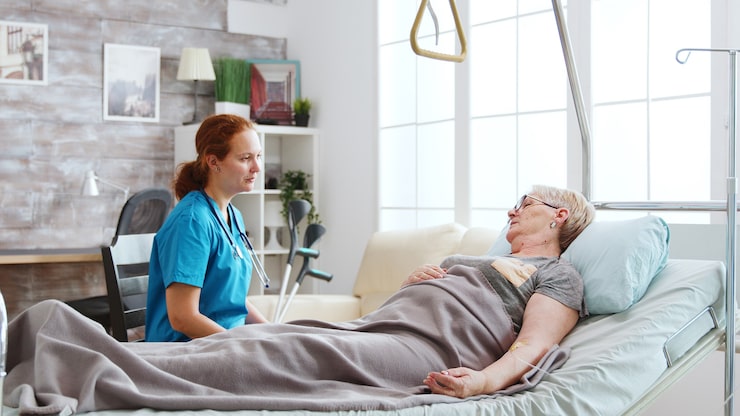 http://nurse-retirement-home-talking-with-old-lady-lying-hospital-bed-big-windows-with-bright-light-are_482257-20748